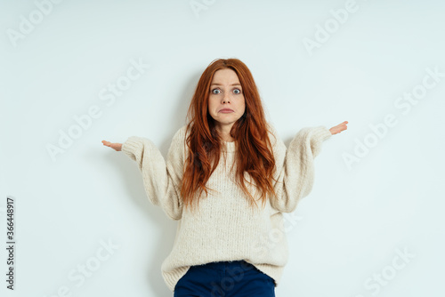 Принти на полотні Confused young woman shrugging her shoulders