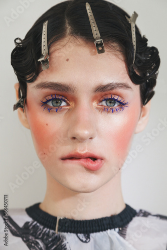 Beauty fashion portrait of young woman with retro makeup and hairstyle. Blue eyelashes