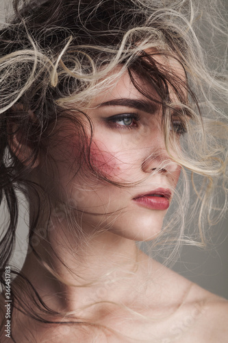Fashion studio portrait of woman with creative hairstyle