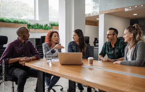 Diverse team of businesspeople having a meeting around a table