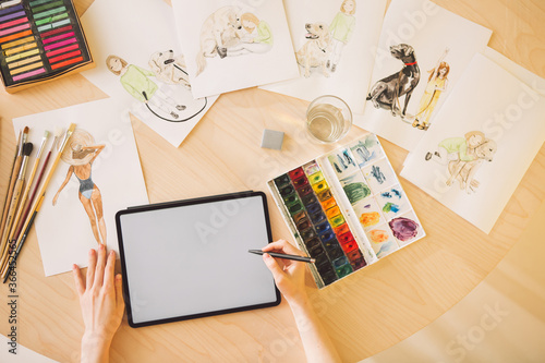 Illustrator girl draws on a graphic tablet with blank screen. Close up photography for ad drawing school or blog