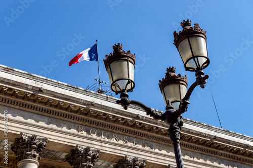 Paris, France - September 02 2019: Paris Bourse stock exchange building (Brongniart palace) with streetlamp in foreground. photo
