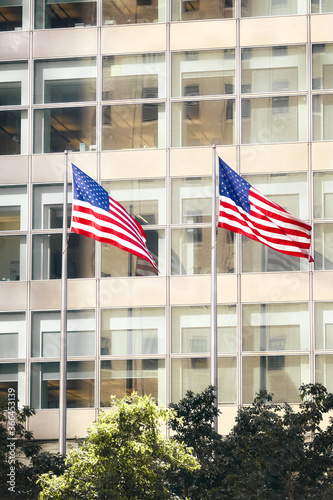 Two American Flags in front of an office building, New York City, USA.