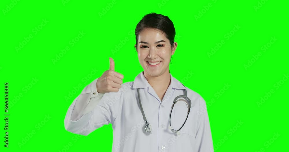 Female doctor rise her hand mean approve with smile face at green screen background. Female doctor rise her hand mean approve with smile face at green screen background.