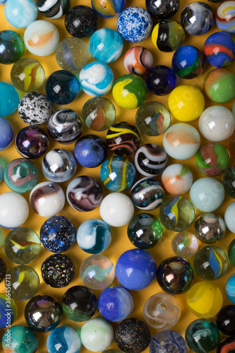 Colorful Marble Balls on Yellow background. Abstract Pattern