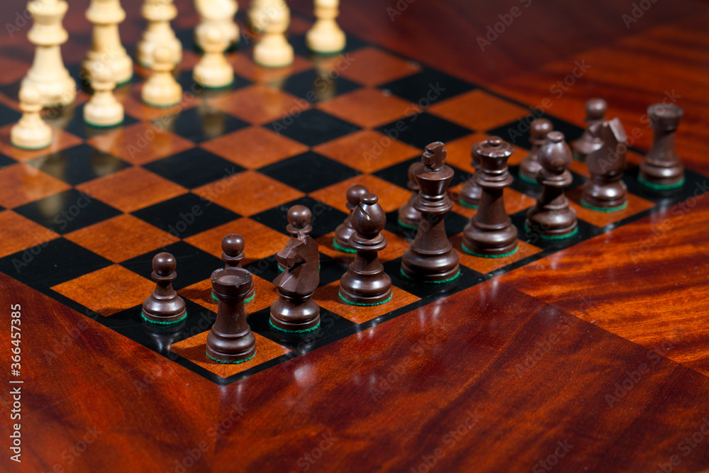 Set of chess figures on wooden playing board Set of chess figures on wooden playing board