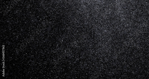 Natural white winter snowfall on a black background