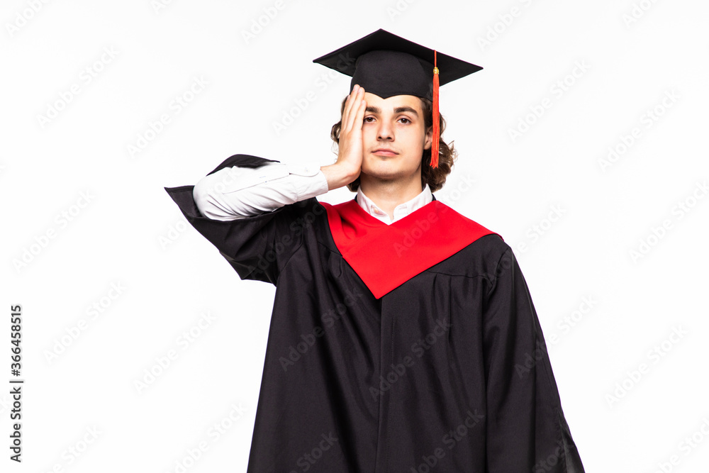 Man on his graduation day University having doubts and with confuse face expression while raising hands and shoulders Uncertain concept on isolated white background Man on his graduation day University having doubts and with confuse face expression while raising hands and shoulders Uncertain concept on isolated white background
