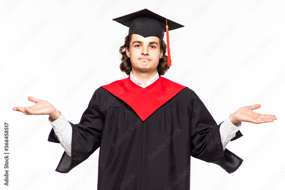 Man on his graduation day University having doubts and with confuse face expression while raising hands and shoulders Uncertain concept on isolated white background Man on his graduation day University having doubts and with confuse face expression while raising hands and shoulders Uncertain concept on isolated white background