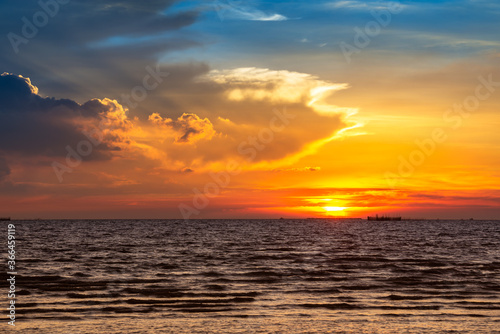 Beautiful sunset at the sea and motion blur cloud on sky