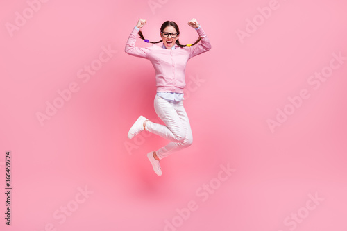 Full length body size view of her she nice attractive overjoyed satisfied crazy lucky cheerful cheery glad teen girl jumping rejoicing having fun attainment isolated pink pastel color background