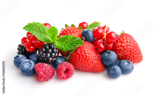 Pile of assorted wild fresh berries isolated on white background.