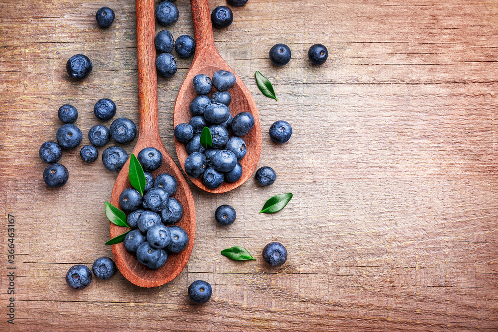 Wooden spoons with fresh ripe blueberries Wooden spoons with fresh ripe blueberries