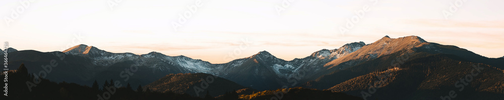 Panoramic photo of autumn mountain valley. Amazing sunset in the mountains, autumn in the mountains. Travel and hik concept.