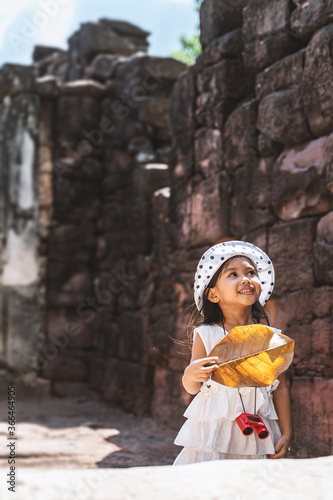 A girl is touring ancient stone castle. © Cheangchai