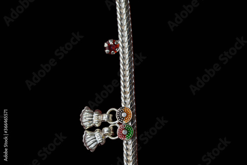 Photography Beautiful silver anklet is curled up
