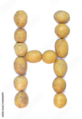 Letter H of the English alphabet from potatoes. A letter made of fruit on a white background.