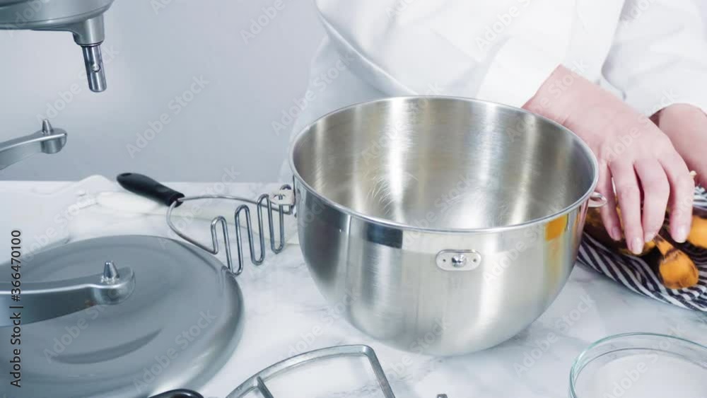 Time lapse. Step by step. Mixing ingredients together into a metal mixing bowl to bake banana bread.