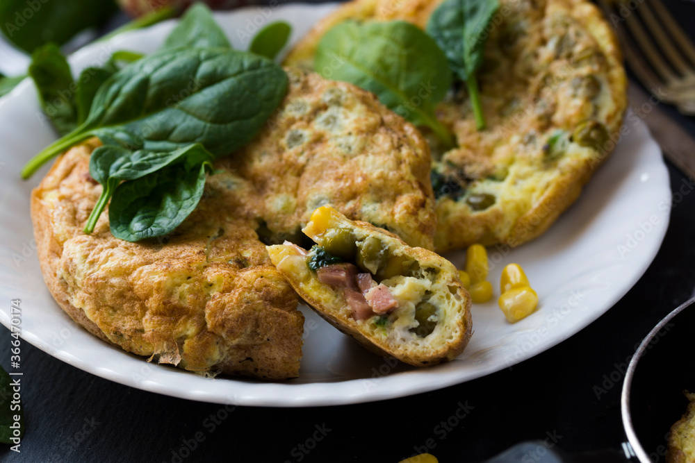 An omelette with sweet corn, green peas and spinach. An omelette with sweet corn, green peas and spinach.