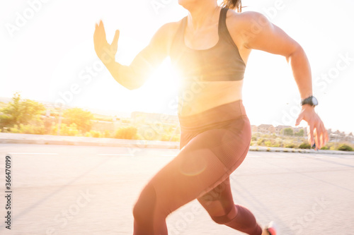 Athletic woman running in the street