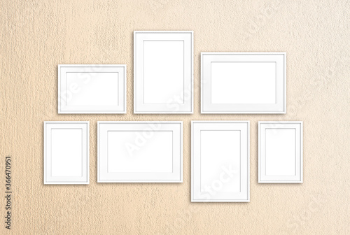 White frames collage isolated on light yellow painted wall, interior decor mock up