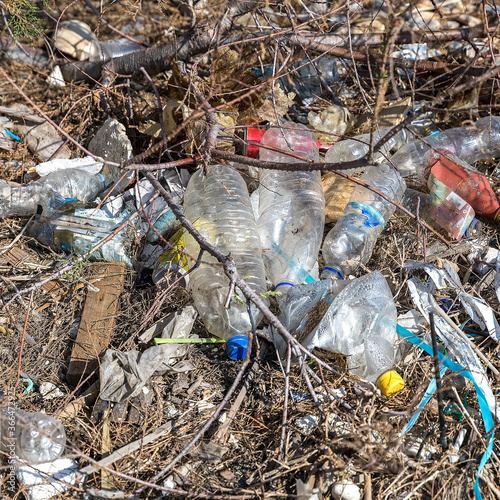 Ground Pollution In Environment. Garbage pile   of plastic bottles and various rubbish on the beach near the big city. Stock image
