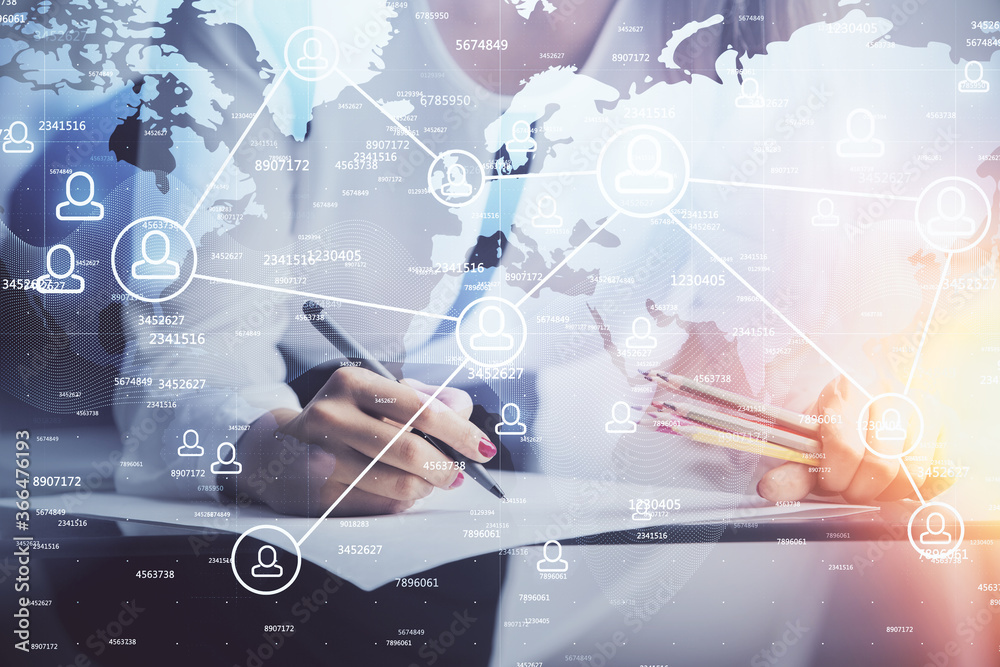 Social network theme hologram over hands taking notes background. Concept of global international people connect. Double exposure Social network theme hologram over hands taking notes background. Concept of global international people connect. Double exposure