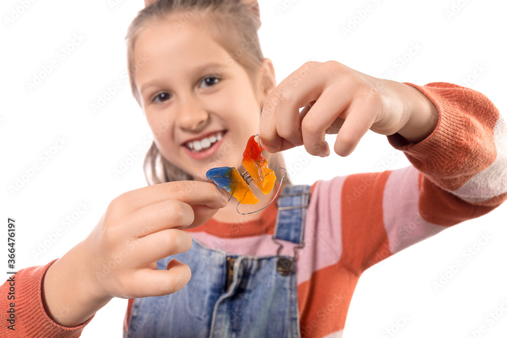 Little girl with orthodontics appliance isolated on white background. Little girl with orthodontics appliance isolated on white background.