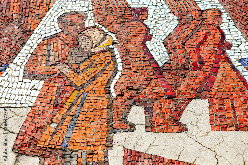 Multicolored mosaic panel of red-orange smalt, elements of the old Soviet monument