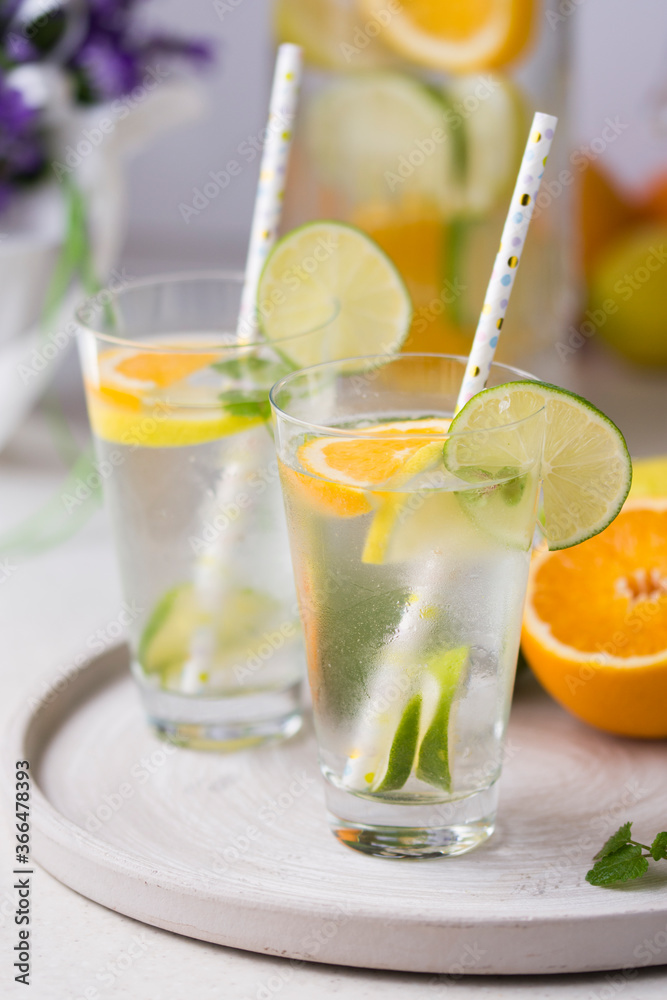 Fototapeta premium Water with fresh orange, lemon and lime slices.