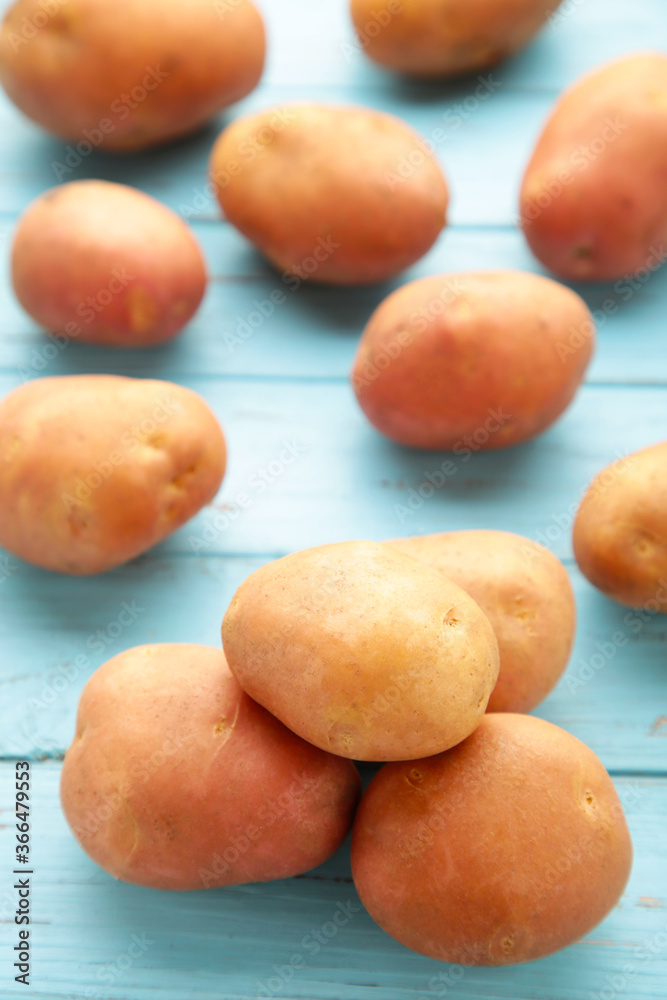 Potatoes on blue wooden background, top view Potatoes on blue wooden background, top view
