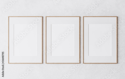Fototapeta Naklejka Na Ścianę i Meble -  three wooden frame on white wall, frame mockup, 3d render