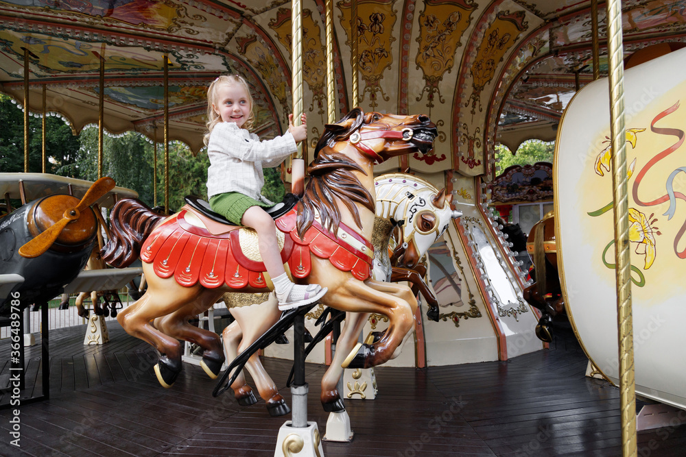 Little girl in an amusement park rides