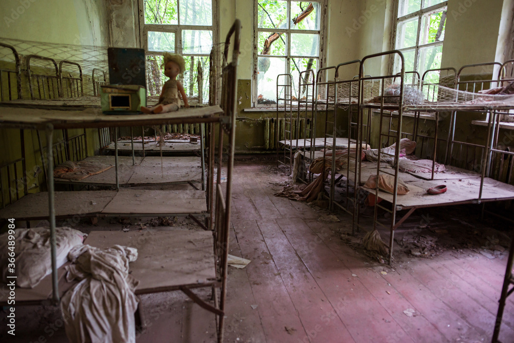 crowded and rusty iron bunk beds in old Pripyat room