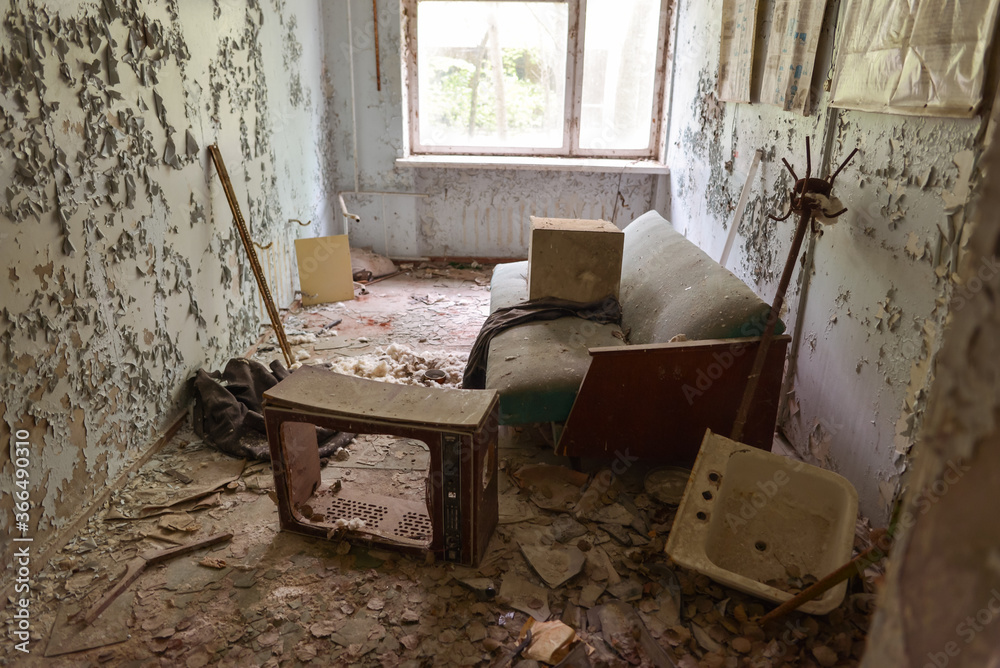 sofa and television in destroyed living room in abandoned Pripyat