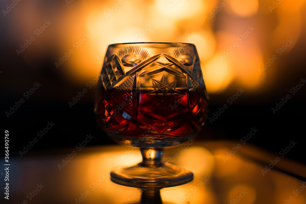 Glass of wine in front of a hot fireplace. Glass of wine in front of a hot fireplace.
