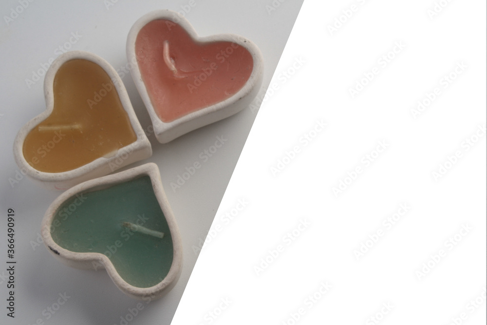 image with white part and photo of three candles with colored wax in the shape of a heart image with white part and photo of three candles with colored wax in the shape of a heart