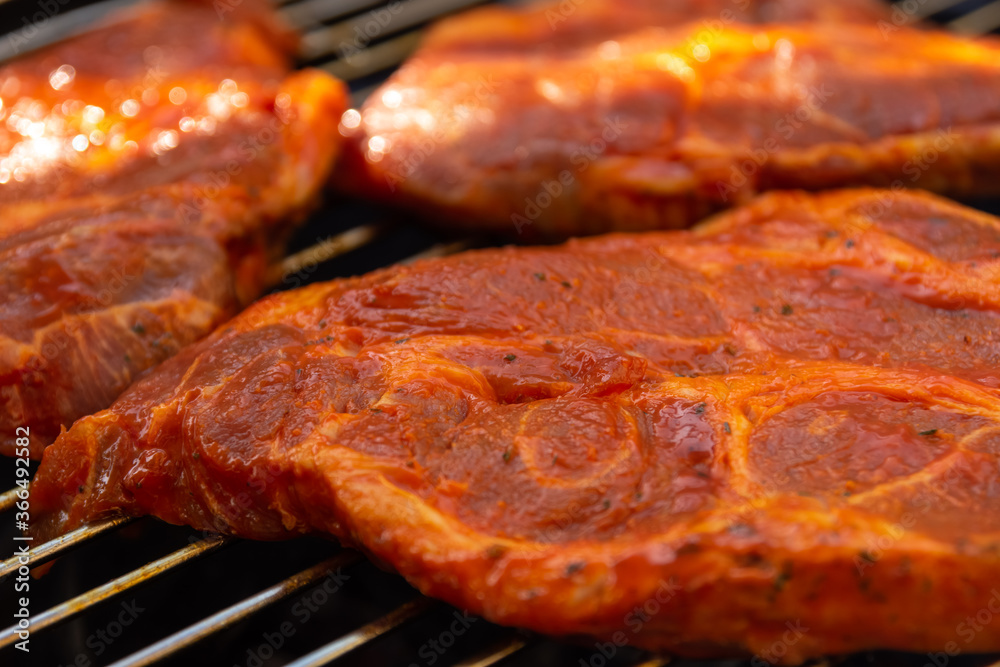 Seasoned meat cooking on a barbecue grill