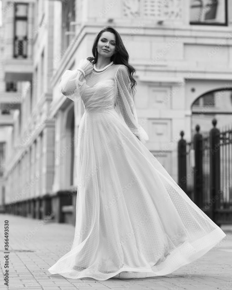 Young beautiful woman wearing long pink dress. Outdoor fashion full length portrait. Young beautiful woman wearing long pink dress. Outdoor fashion full length portrait.