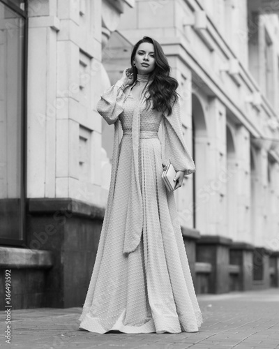 Wallpaper Mural Fashion outdoor portrait. Young stylish woman in long pink evening dress walking at city street on a summer day. Full length Torontodigital.ca