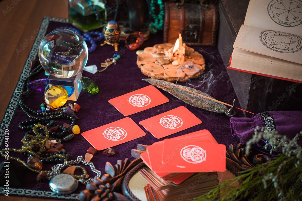  Tarot cards, Concept of fortune telling and predictions, magical rituals and wicca elements on a table