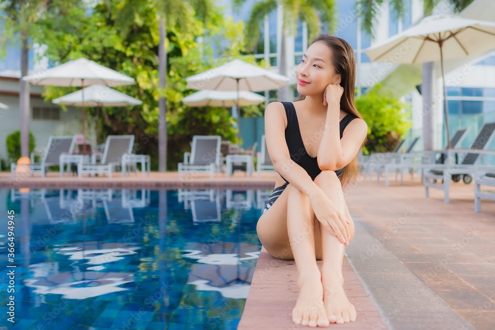 Portrait beautiful young asian woman leisure relax smile around outdoor swimming pool