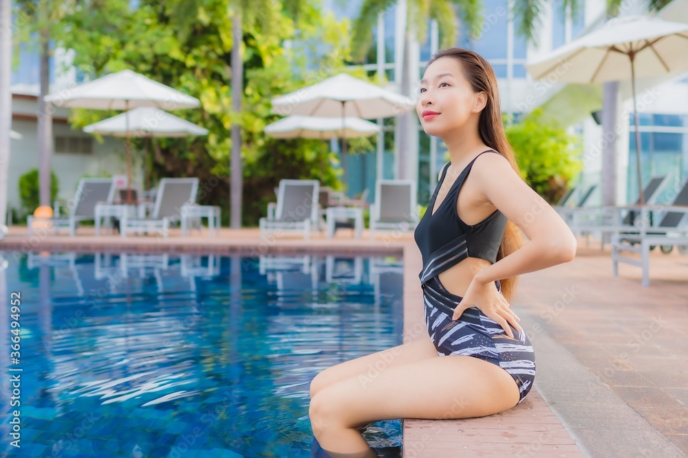Portrait beautiful young asian woman leisure relax smile around outdoor swimming pool