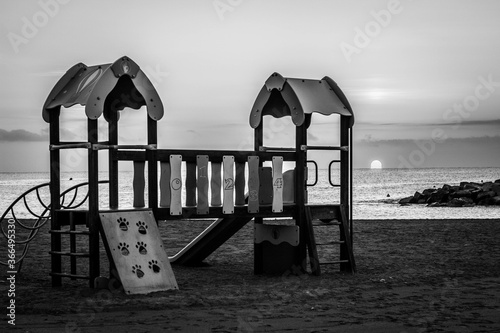 Greyscale shot of a children's playground  at the beach in Vinaros, Castellon, Spain photo