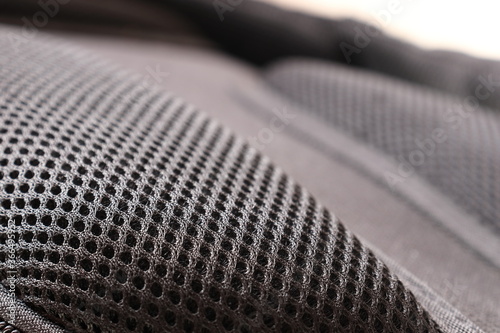 Close up view of breathable mesh fabric of the black backpack