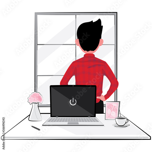 A man take a break from business at work looking out from the window and turn his back from computer