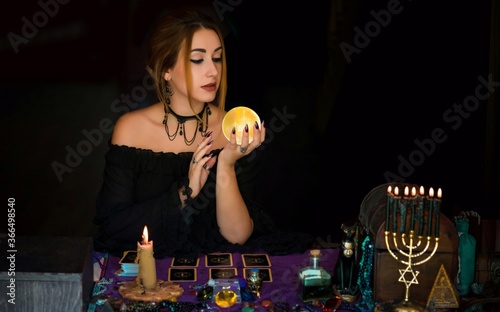  Woman fortune teller on a crystal ball, Concept of predictions, magic rituals and wicca photo