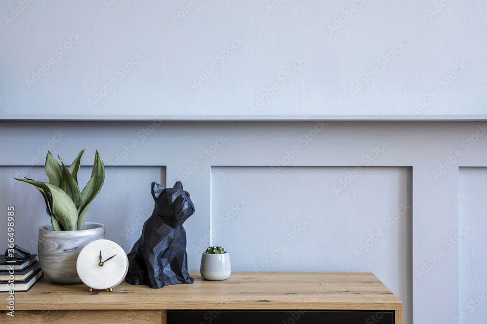Stylish scandinavian composition with wooden commode, candle, succulent in pot, books, white clock, decoration, copy space and gray wood paneling in modern concept. - obrazy, fototapety, plakaty 