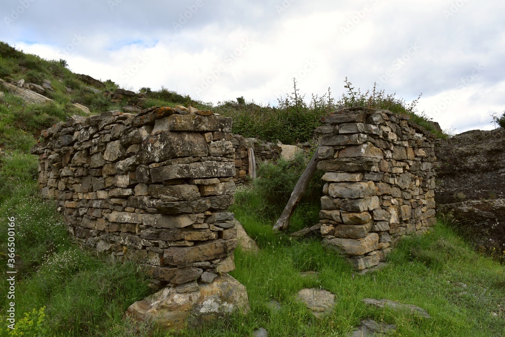 Old dry stone corral destroyed by the passage of time on top of the mountain. Animal and shepherd shelter, protected from the north wind.