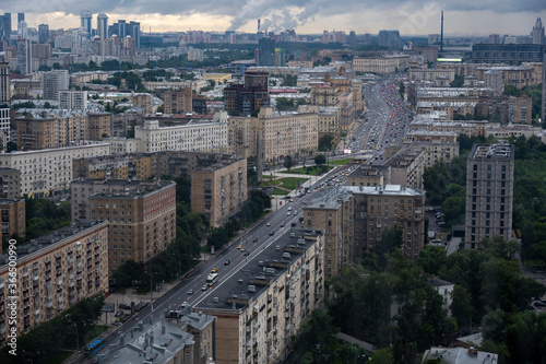 a view of a big city through the window where you can see that it is raining outside